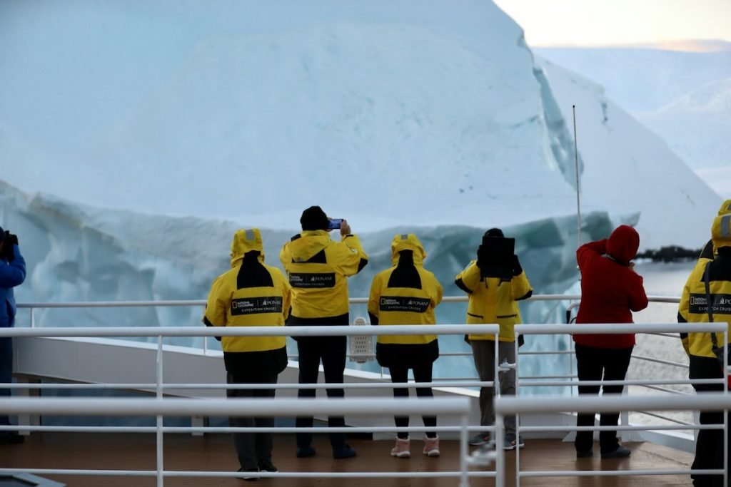 Expedition cruise ship navigating heavy sea ice in Antarctica in November