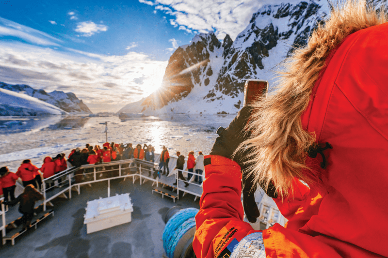 Expedition cruise ship sailing among icebergs on the Antarctic Peninsula