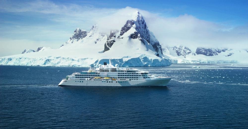 Luxury expedition cruise ship sailing through Antarctic ice and glaciers