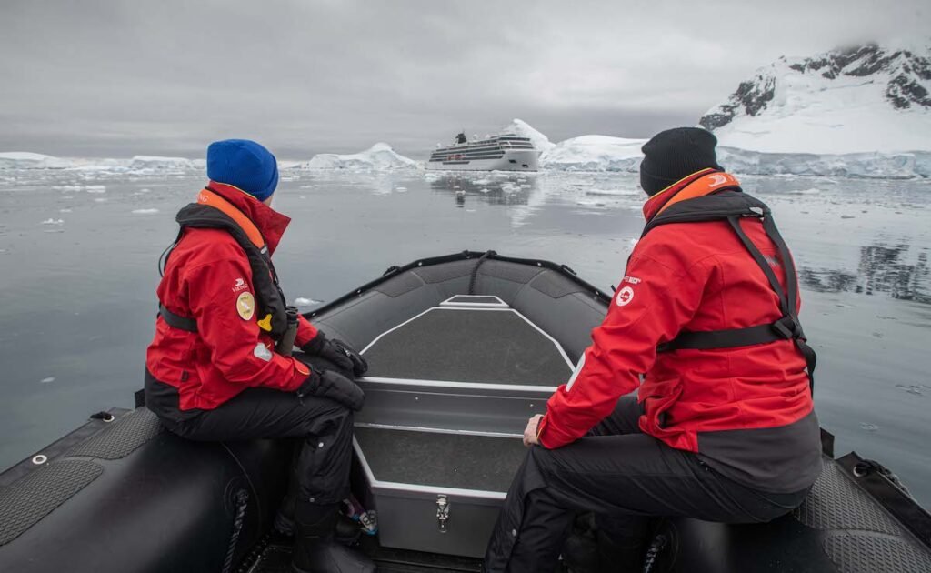 Passengers landing in Antarctica via zodiac boat during expedition